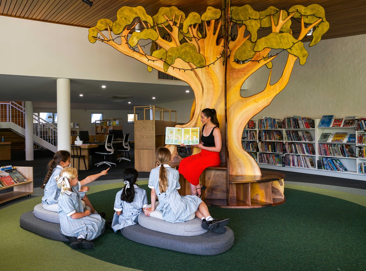 Loreto College Library, students gathered around junior school reading tree